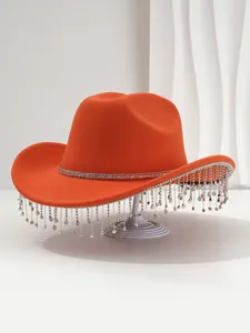 Close-up of an orange luxury cowboy hat featuring long sparkling rhinestone fringe