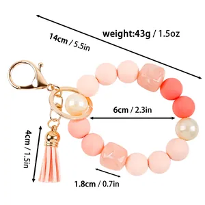Close-up showing the dimensions and weight of this pink silicone beaded wristlet keychain