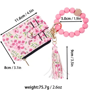 Detailed view of floral card holder with pink silicone wristlet and dimensions