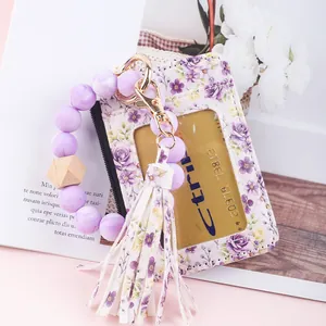 Detailed view of the floral print leather ID holder with purple bead bracelet