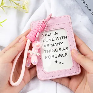 Close-up of pink faux leather ID card holder with braided rope and balloon dog charm