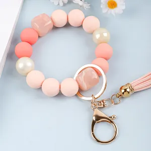 Detail of candy-colored silicone bead wristlet keychain with pink leather tassel