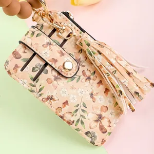 Close-up detail of floral print leather card holder featuring silicone bead wristlet