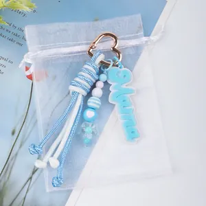 Detailed view of handmade blue rope keychain with heart clip and Mama tag