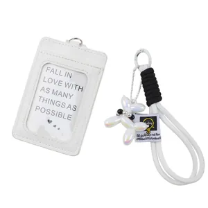 Detail view of white ID card holder and balloon puppy braided keychain set