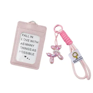 Detail view of pink fabric ID card holder set with braided lanyard and balloon dog