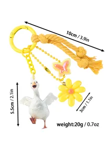 Detail view of goose keychain with flower and butterfly charms showing dimensions and weight