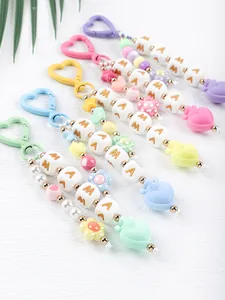 Detail of colorful silicone beaded keychains with MAMA letter cubes and heart charms