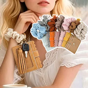 Detail of PU leather card holder keychain with scrunchie wristlet and tassel charm
