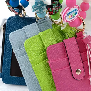 Detail of colorful pebbled leather vertical card holders with silicone bead keychains.