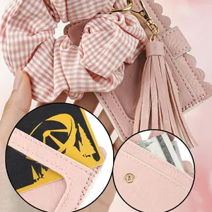 Detail of pink PU leather card holder keychain with scrunchie and tassel