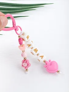 Close-up of pink silicone beaded keychain with MAMA letter beads and heart charm.