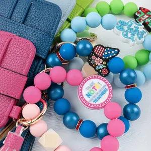 Close-up view showing colorful silicone bead wristlet keychains and leather card wallets