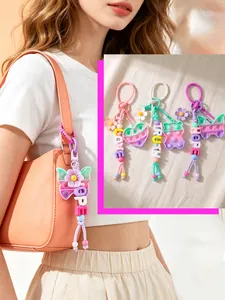 Close-up of colorful pop-it butterfly and heart keychains with letter beads on a bag