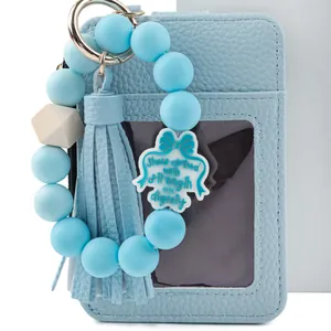 Light blue textured leather card holder with matching silicone bead keychain and tassel.