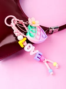Detailed macro view of a pink pop-it heart keychain with colorful LOVE letter beads