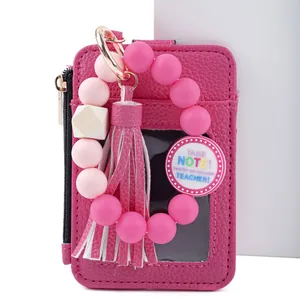 Pink leather card holder with beaded keychain and teacher appreciation tag detail.