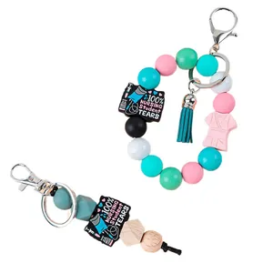 Porte-clés de poignet en perles de silicone pour infirmières avec pompon et breloque