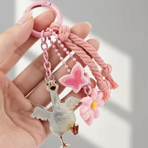 Ins style pink keychain featuring a realistic white goose, flower and butterfly charms