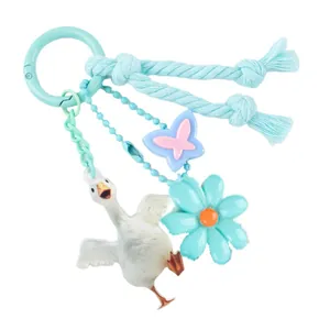 Pastel blue goose keychain pendant featuring flower and butterfly charms on woven rope