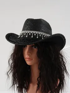 Detailed view of a black sequined cowboy hat with elegant rhinestone and pearl fringe.