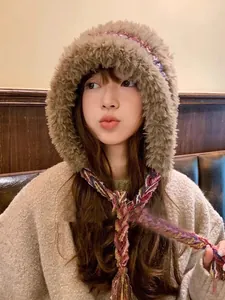 Close-up of a cozy plush hooded winter hat with colorful braided ties for women