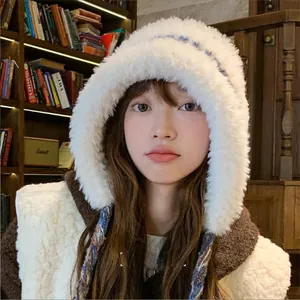 Stylish cozy white plush earflap hat with tie straps for winter outdoor warmth.
