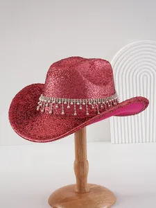 Detailed view of red glitter cowboy hat with sparkling rhinestones and pearl fringe