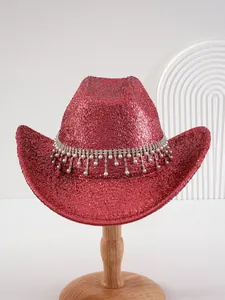 Detail of a sparkling red glitter cowboy hat with rhinestone fringe and pearl tassels.