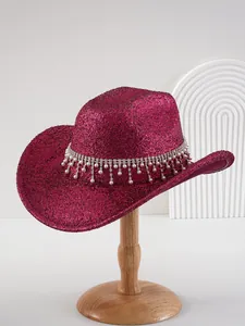 Detail shot of a magenta glitter cowboy hat featuring elegant rhinestone and pearl fringe