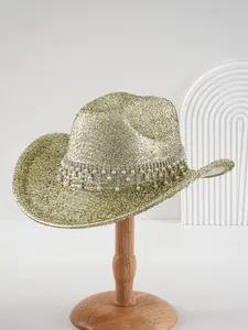 Close-up of luxury metallic cowboy hat with rhinestone band and pearl tassels
