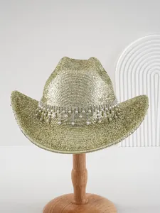 Detail view showing shimmering gold metallic hat with rhinestone band and pearl tassels