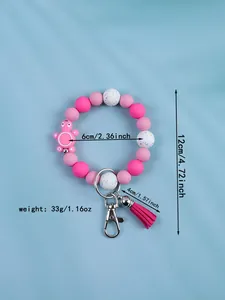 Close-up of pink silicone beaded keychain with turtle charm and tassel showing dimensions.