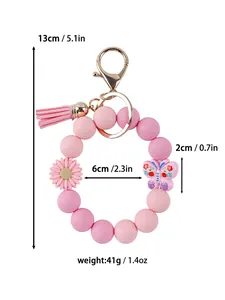 Detailed view showing dimensions of pink silicone bead keychain with daisy and tassel.
