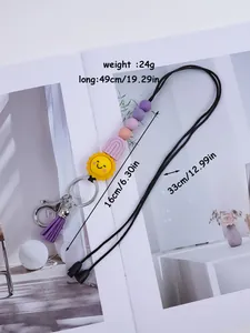 Close-up of handmade cartoon sun silicone bead lanyard with purple tassel keychain