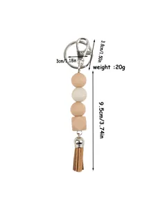 Detailed view of handmade silicone bead keychain with tassel and dimensions