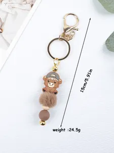 Cute cartoon cow keychain featuring silicone beads and a soft brown fur ball accessory