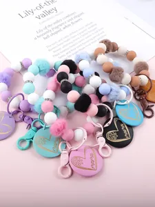 Detailansicht bunter Silikonperlen-Schlüsselanhänger mit Pompons und Mama-Anhängern