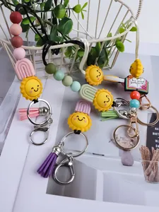 Detailed view of colorful silicone beaded keychains with cartoon sun and tassel charms