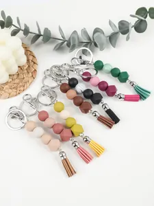 Detailed view of colorful DIY silicone beaded keychains with octagonal beads and tassels