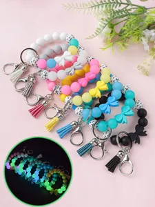 Siliconen kralen polsband sleutelhangers met strikken en PU-kwastjes met lichtgevend effect
