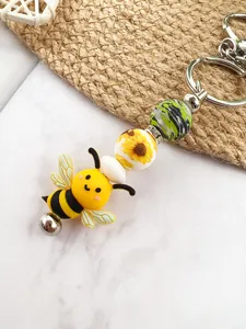 Detailed view of a cute silicone bee charm and sunflower bead keychain pendant