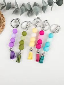 Macro detail of colorful octagonal silicone beads and tassels on keychains
