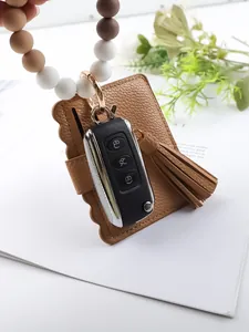 Detailed view of silicone bead bracelet with brown PU card holder and tassel attachment.