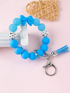 Gedetailleerde weergave van een blauwe siliconen kralenarmband sleutelhanger met strik