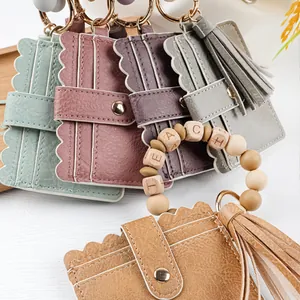 Detailed view of colorful PU leather card holders with TEACH letter bead bracelets and tassels