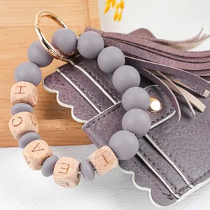 Close-up of Teacher's Day PU leather keychain bracelet with tassel and card holder.