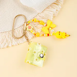 Yellow mini daisy photo album keychain with cute beaded strap and chick charm detail