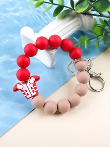 Close-up view of a silicone beaded bracelet with a red football jersey charm and metal clip