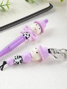 Close-up detail view of a purple cartoon beaded pen and matching keychain with silicone beads